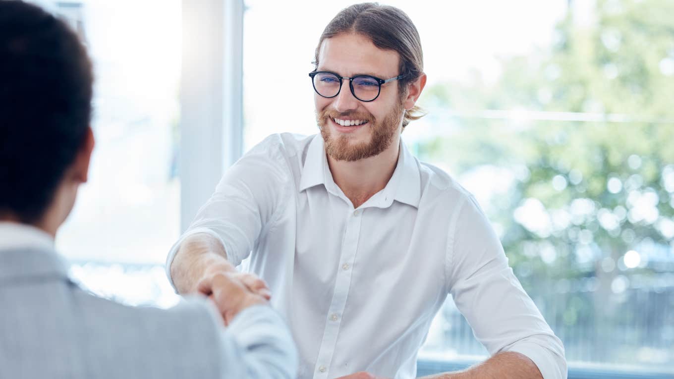 Worker Denied An Entry-Level Interview Because He Doesn't Read Sales Books Or Listen To Podcasts man shaking employers hand during job interview