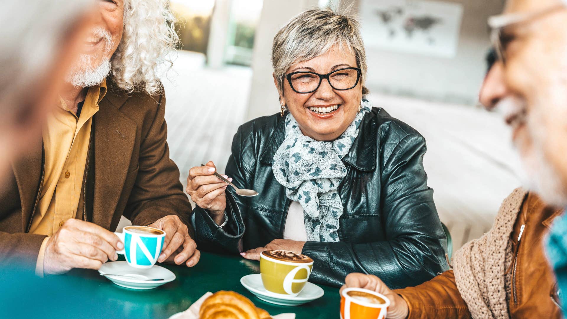 woman who's comfortable with discomfort smiling at a dinner