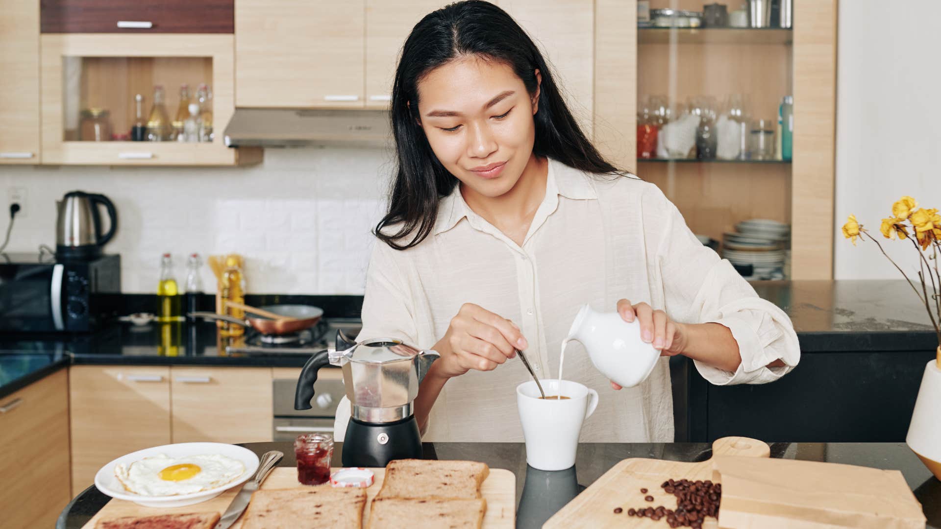 woman who doesn't mind eating alone making coffee