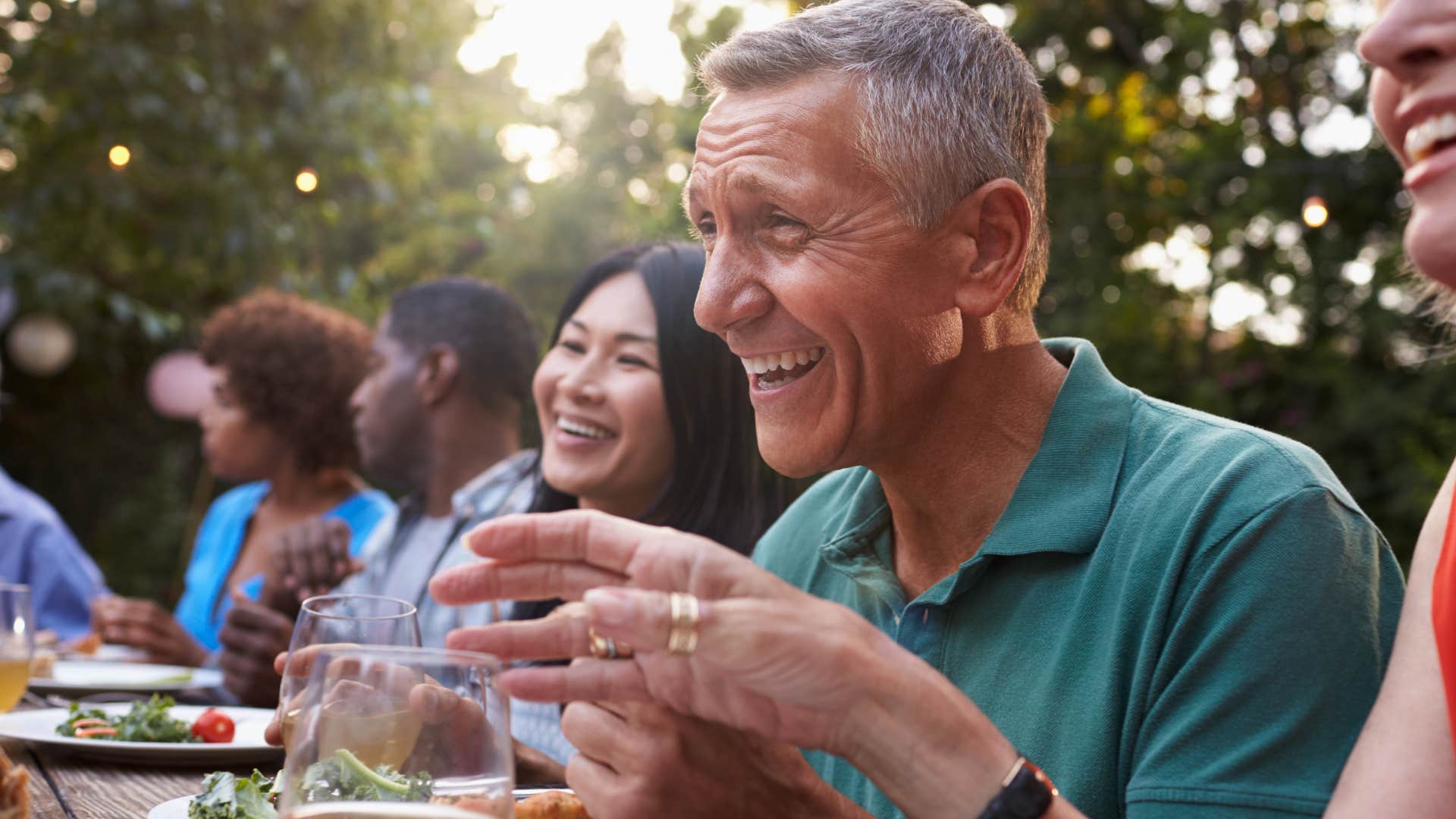 man who eats with intention smiling with friends