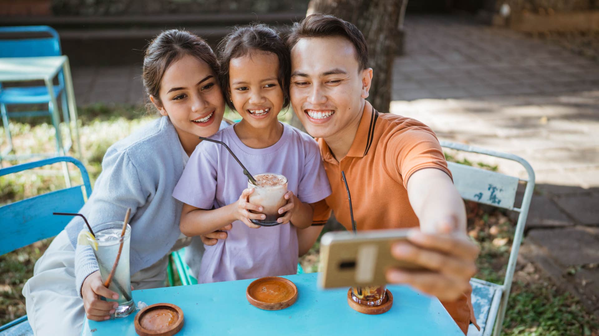 parents taking pictures with their kid