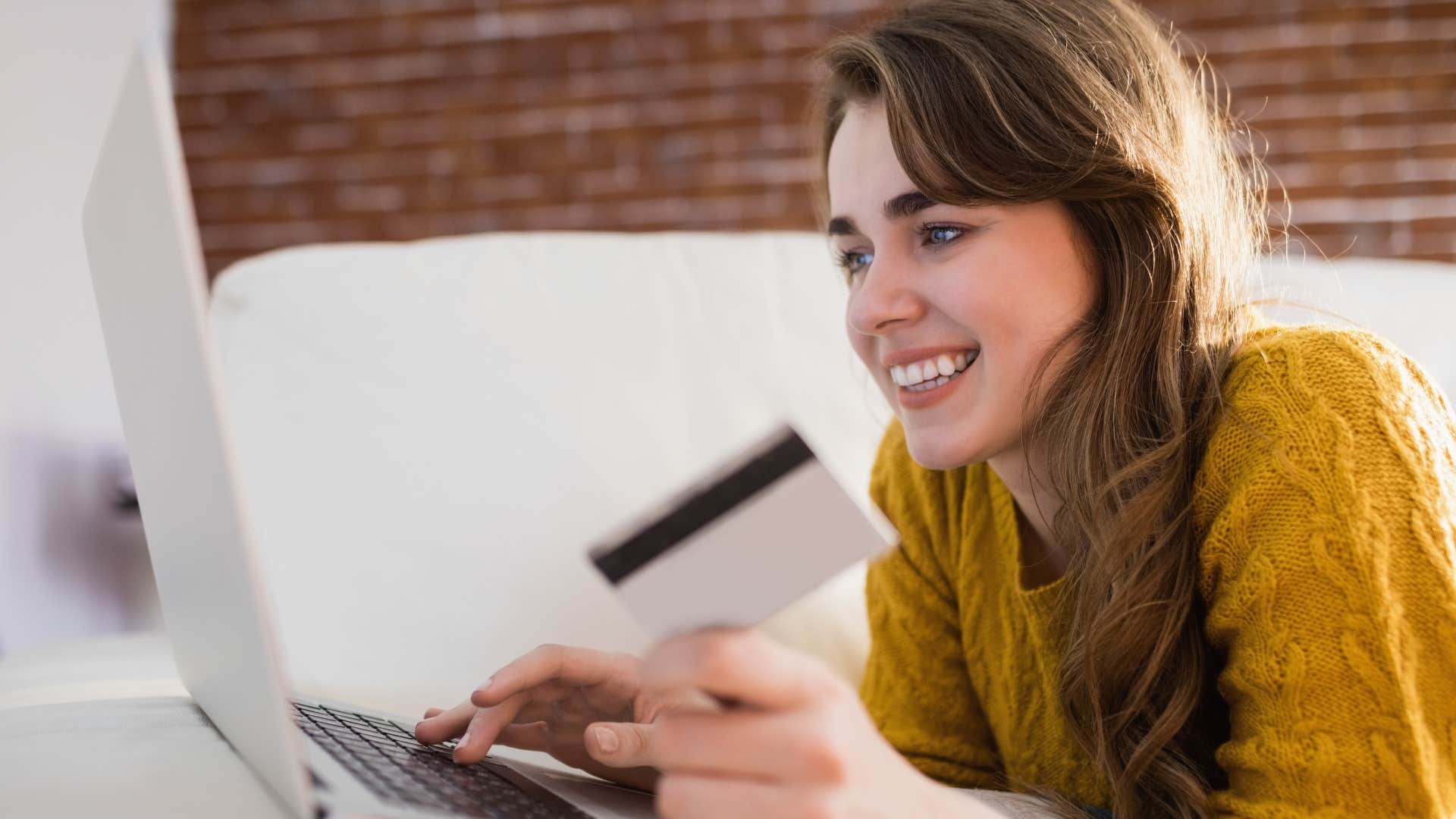 woman thinking about her spending habits making a purchase