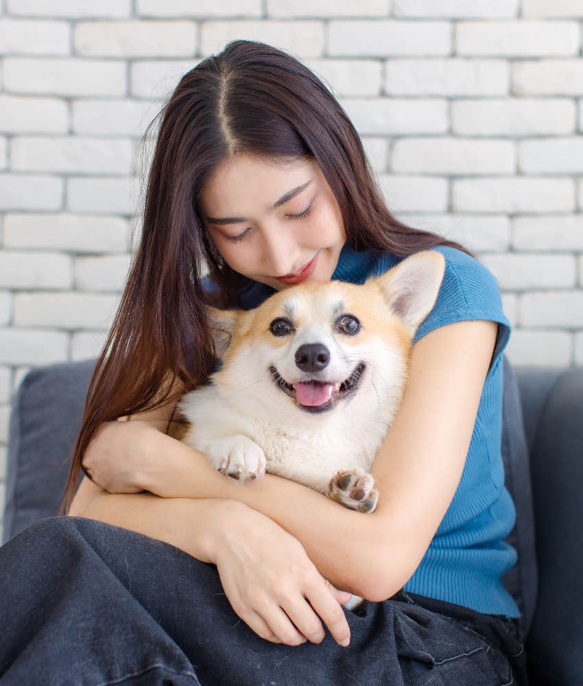 woman hugging affectionate puppy