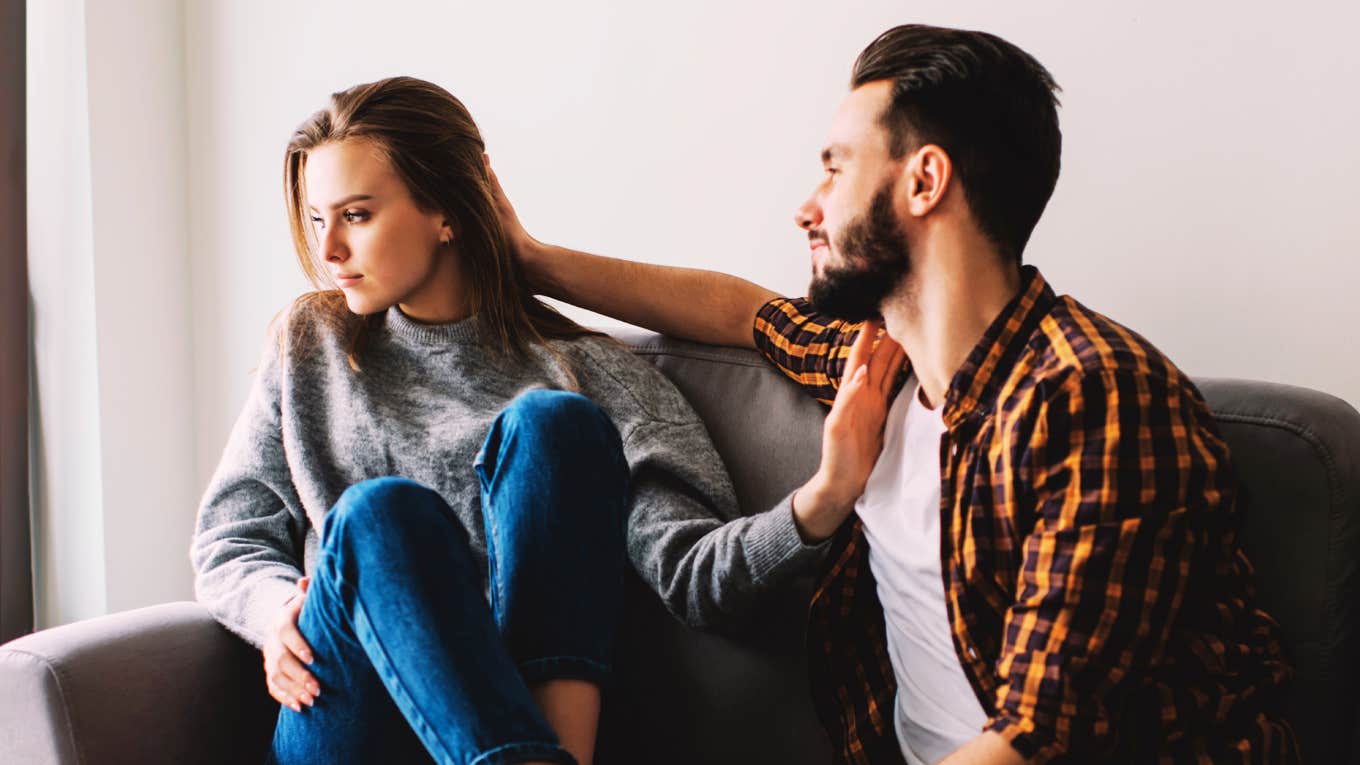 Dissatisfied woman pushing away her boyfriend showing the dynamic of chasing and pulling away and the shifts that change everything.
