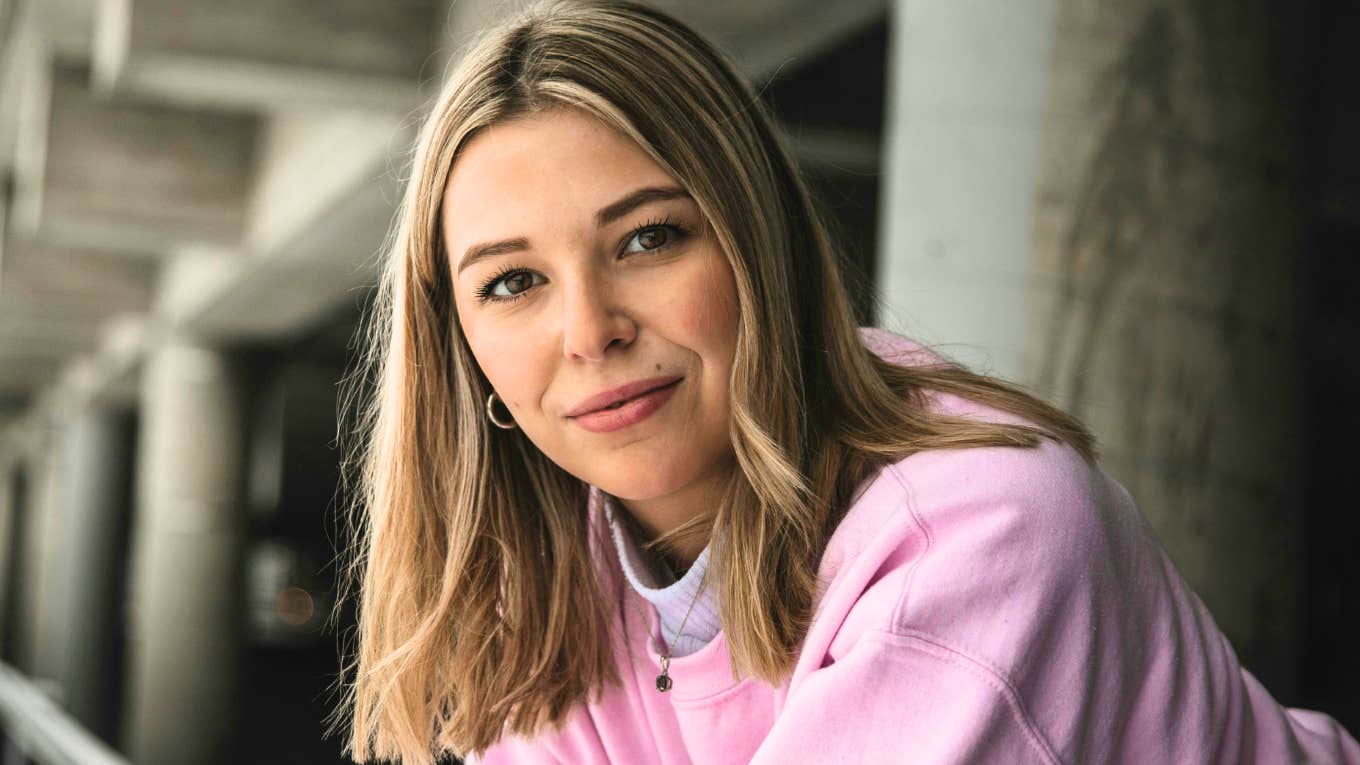 Confident woman standing with strong posture, representing the key obstacles people overcome to become more effective and transform their lives.