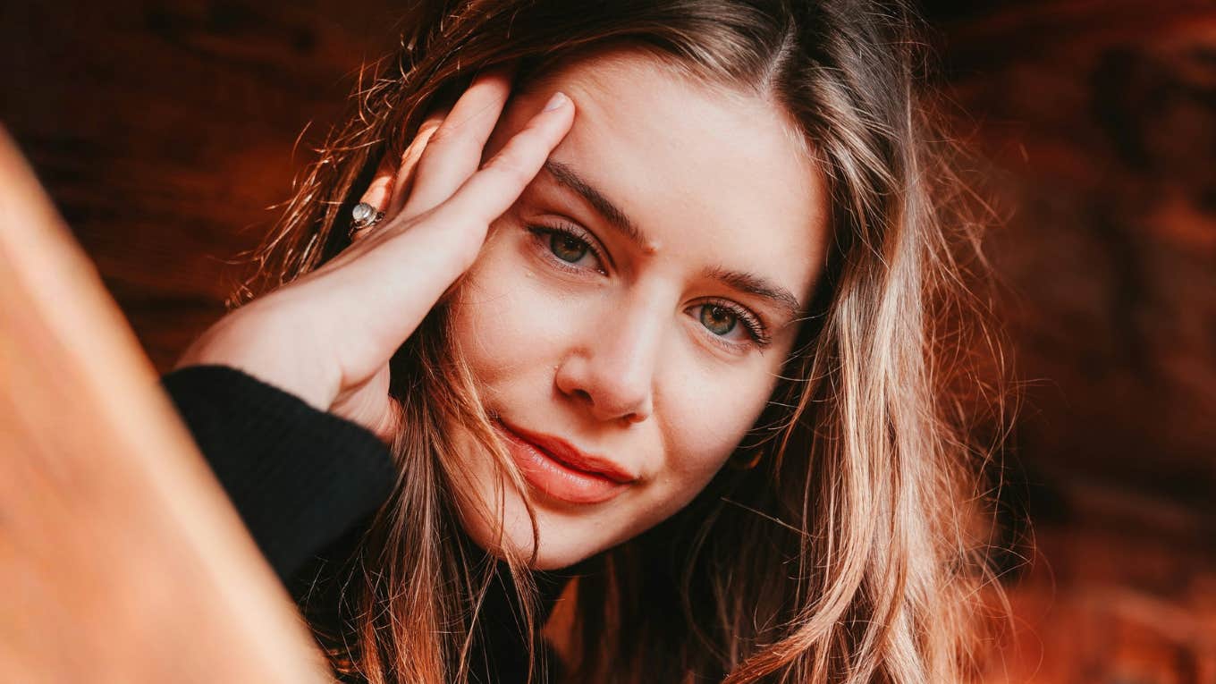 Confident, self-assured woman smiling calmly, embodying the simple habits of naturally secure people