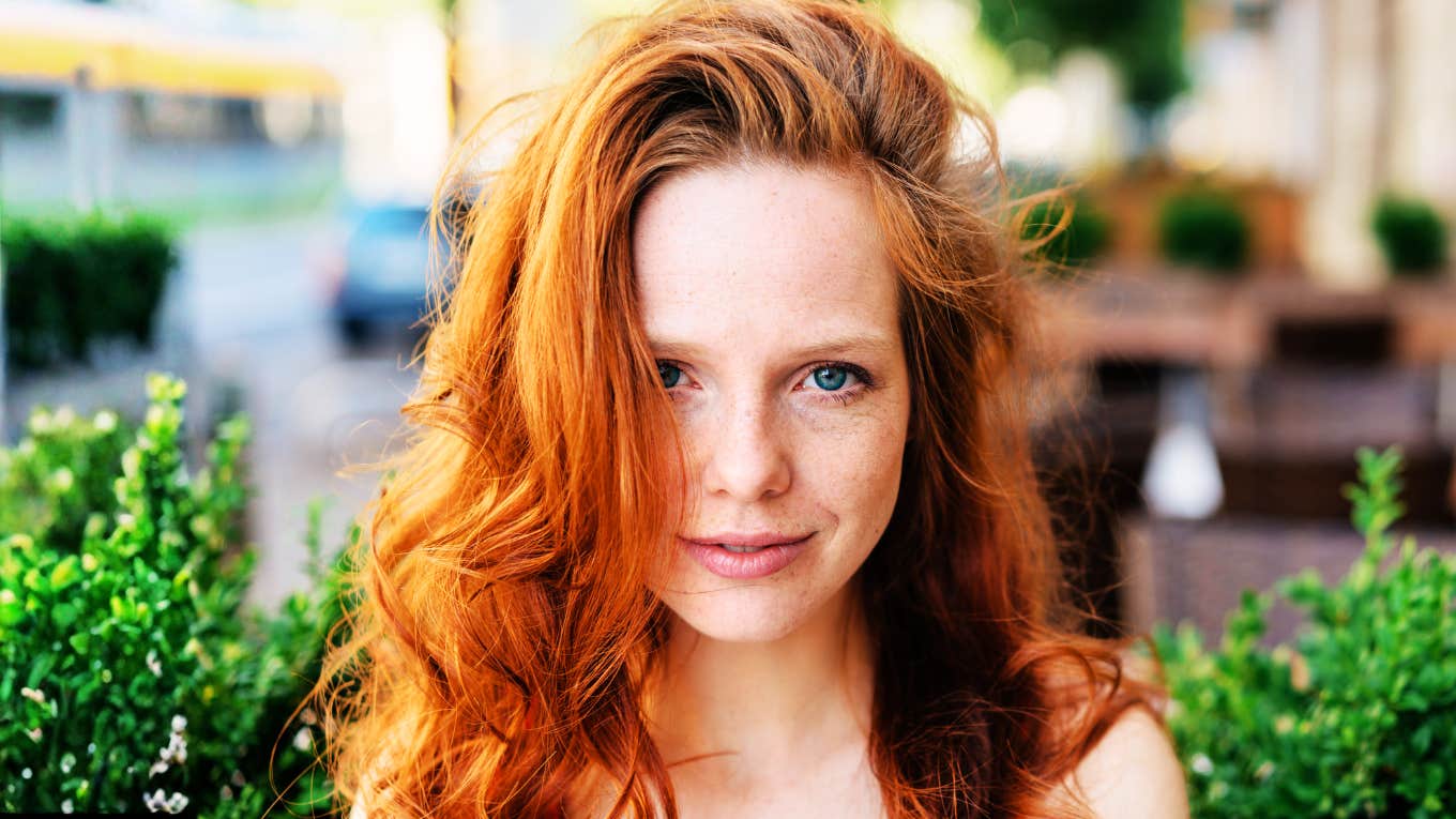 Calm, compassionate woman smiling softly, representing the small acts that can transform the life of someone with anxiety