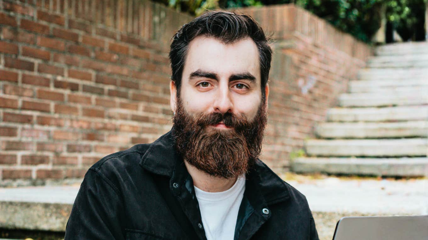 Smiling man outdoors showing the art of unlocking limitless genius