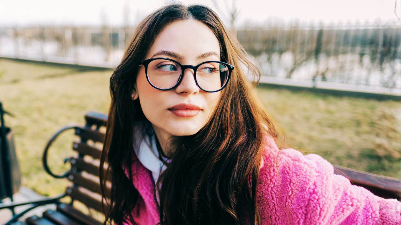 Caucasian woman in glasses reflecting outdoors, embodying simple habits that define impeccable character and accountability.