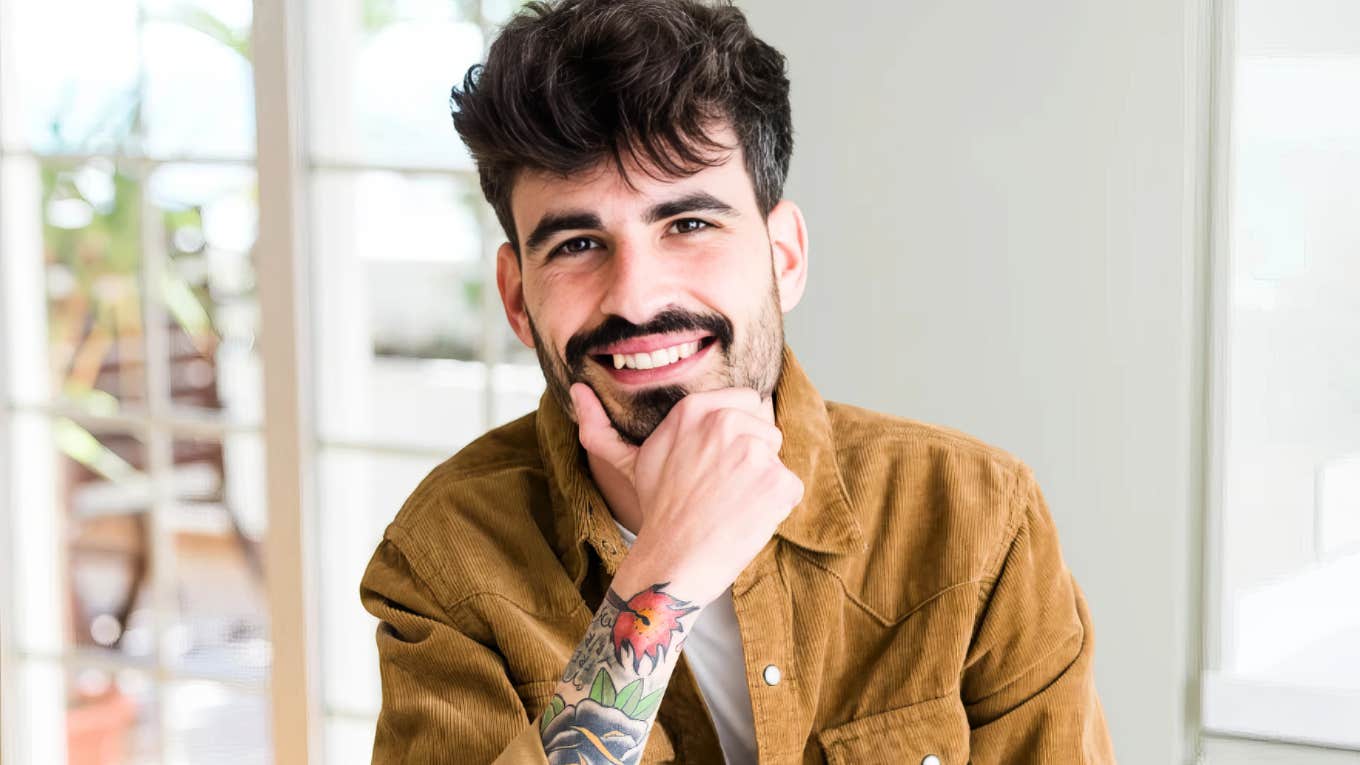 Person making warm eye contact with a subtle smile, embodying the art of likability and psychology-backed tricks that make people instantly warm up to you.