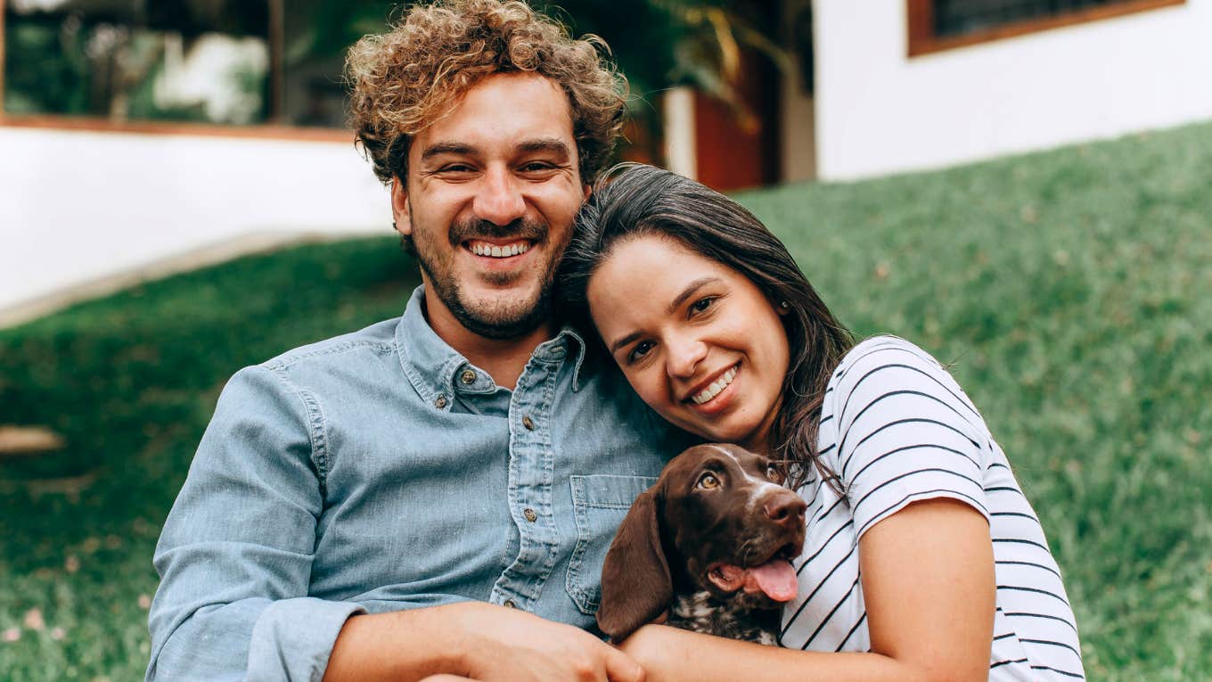 Couple smiling together despite being very different, symbolizing teamwork, understanding, and the emotional intelligence behind strong, healthy relationships.