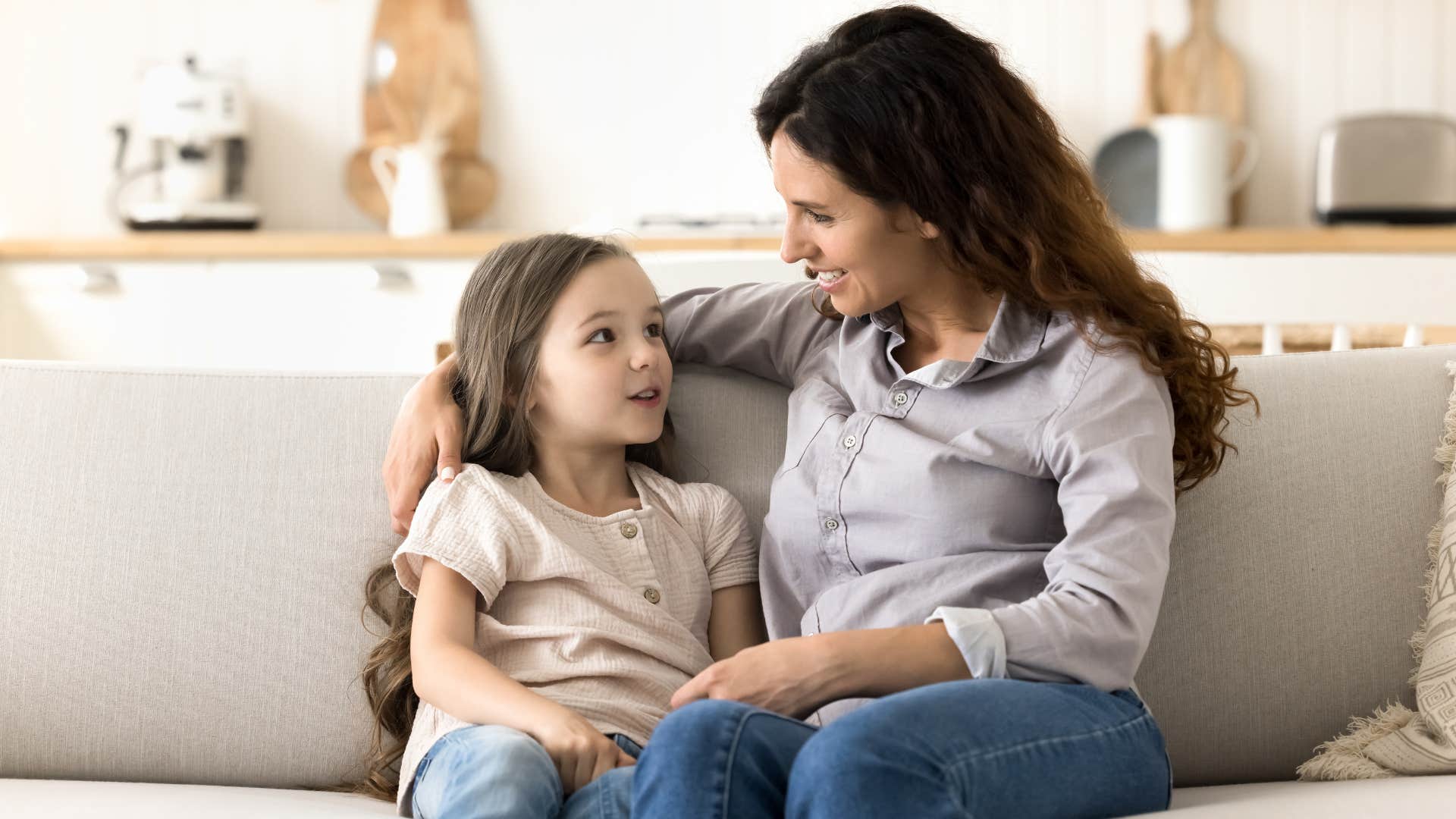 woman helping daughter protect her heart by telling her don't be embarrassed if she likes someone who doesn't like her