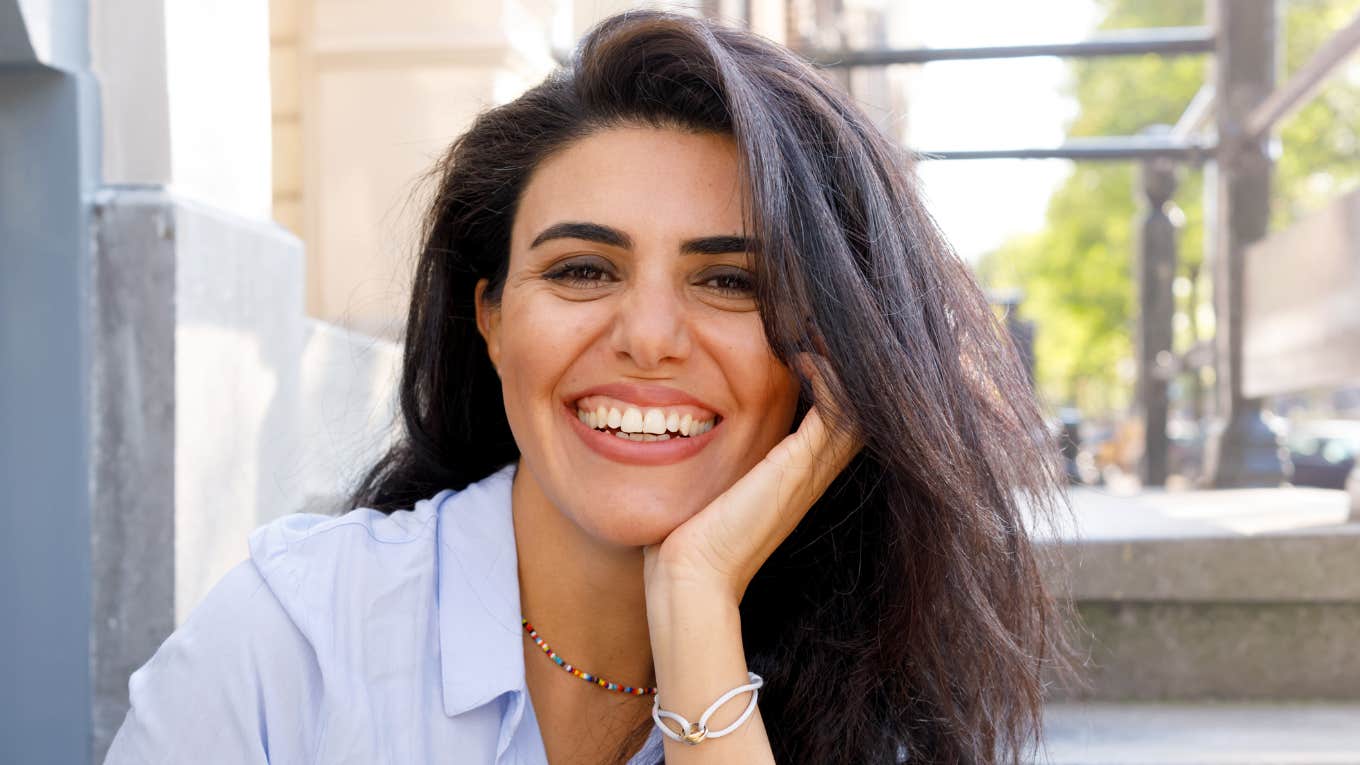 Self aware woman with her hand on her face, representing how other people teach you who you really are