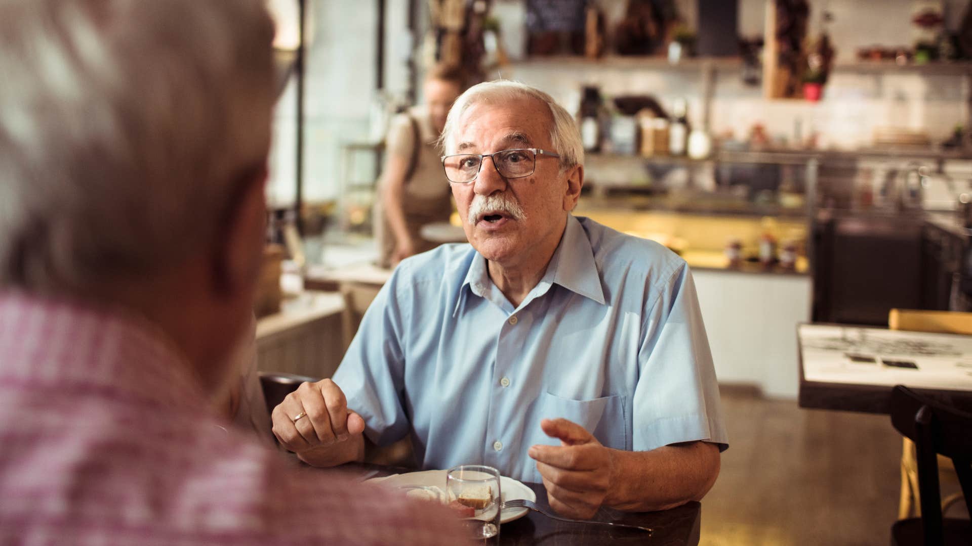 upset man telling wife he wants to talk about something else at meal
