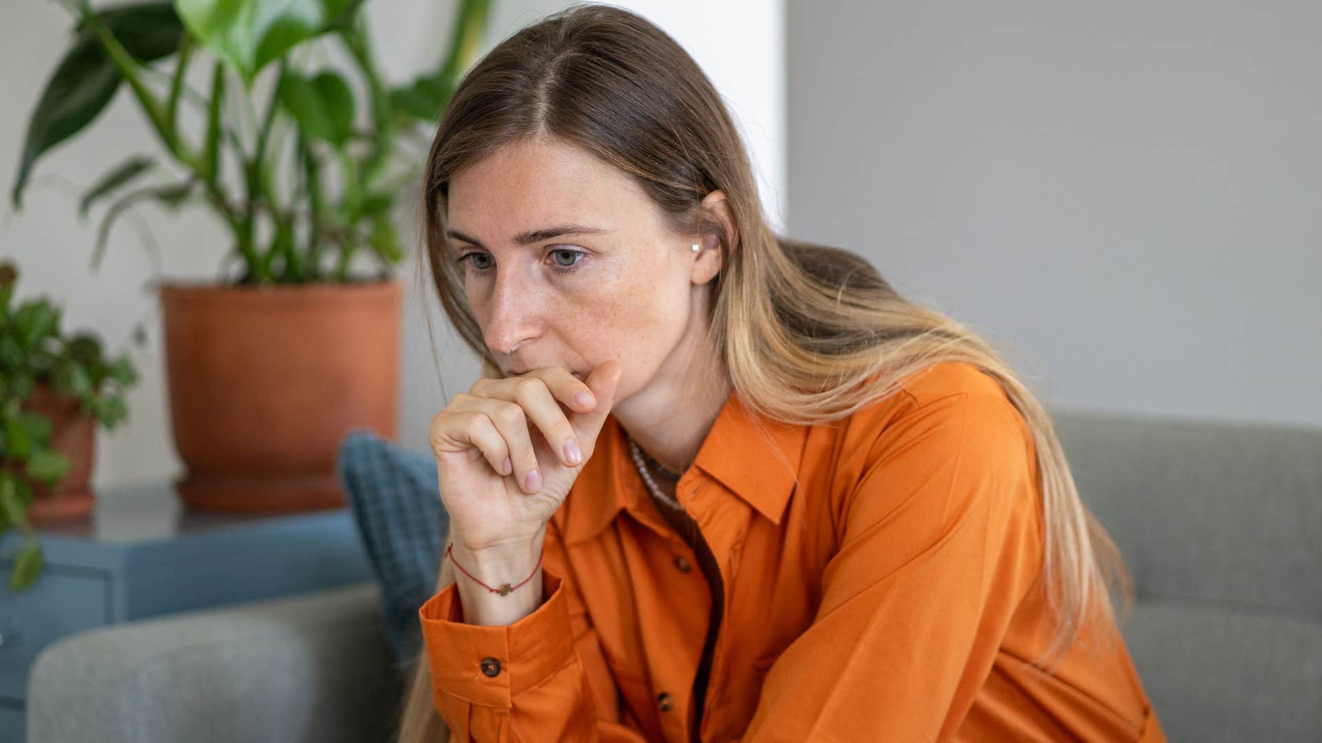 stressed woman ruminating on her couch
