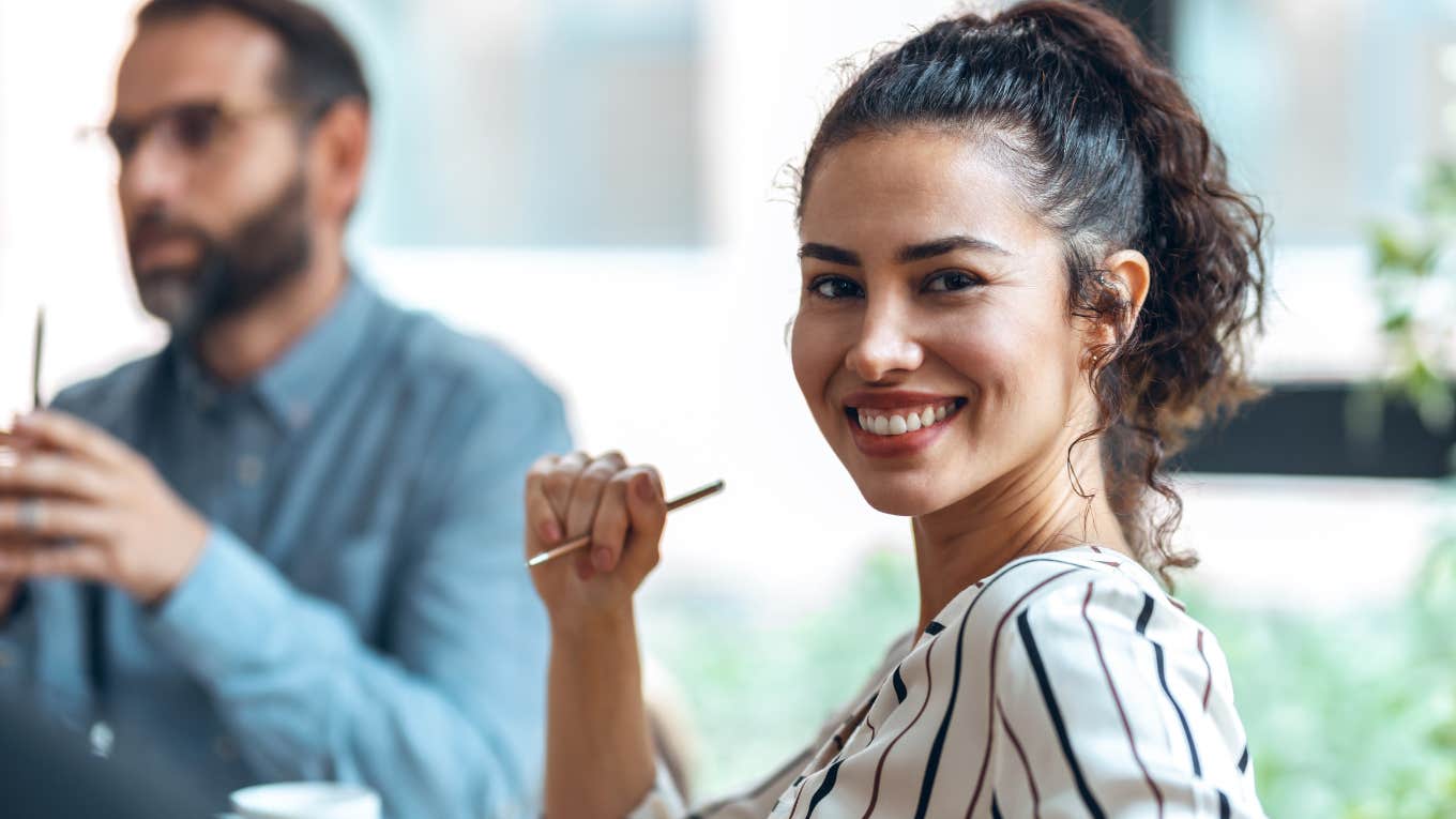 brilliant woman smiling about to shut down mansplainer