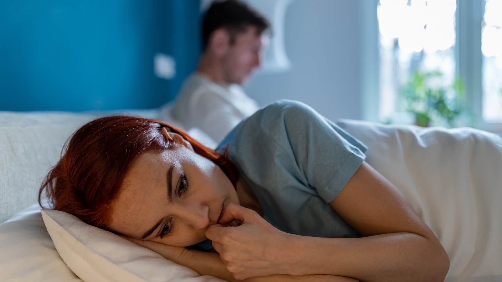 sad woman in bed with husband feeling unseen and unvalued