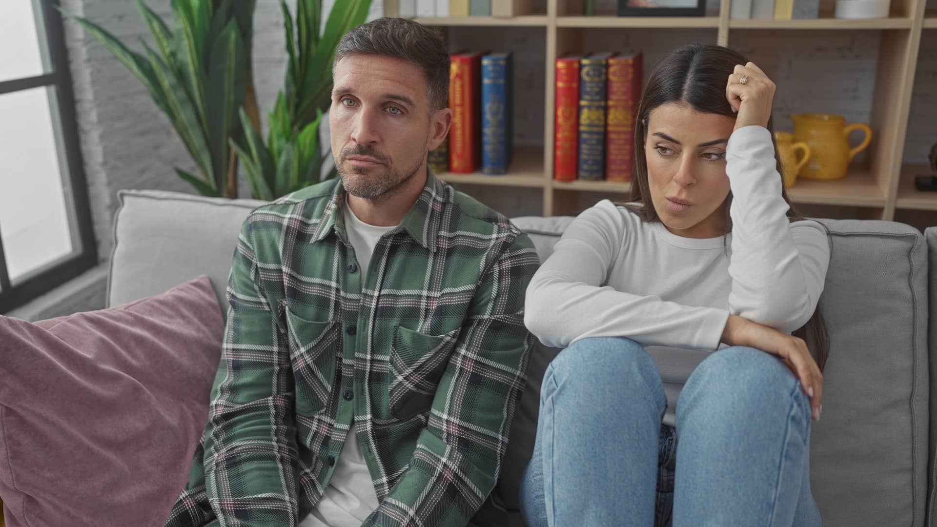 overly stressed couple sitting next to each other in silence