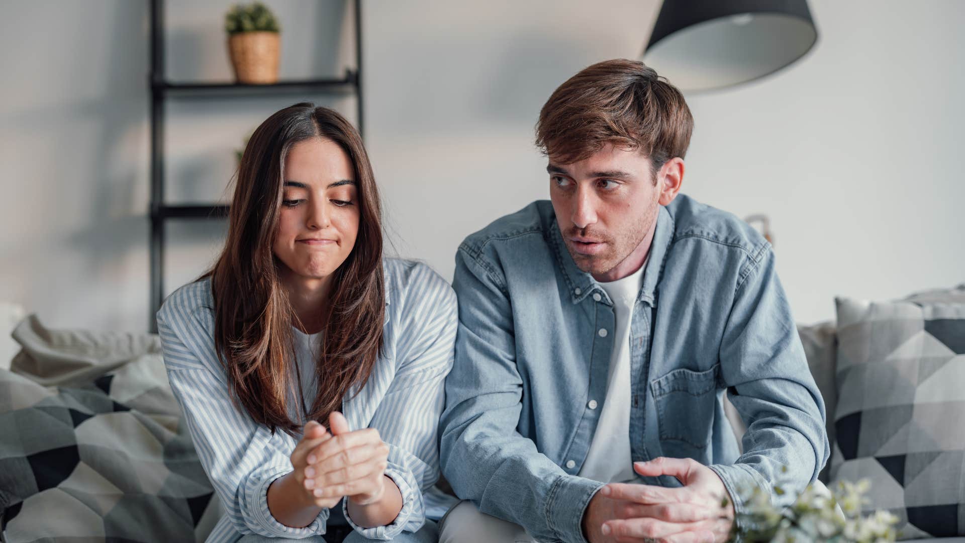couple who are unhappy about love life as sign it's time to go to couples therapy