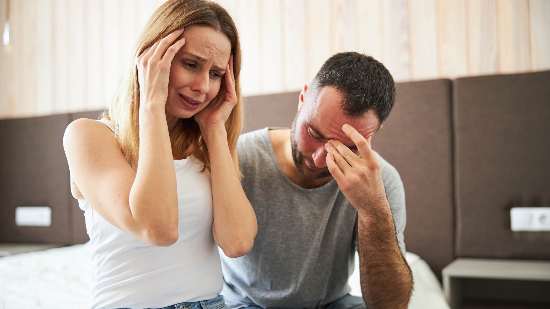 insecure woman crying while partner seems annoyed