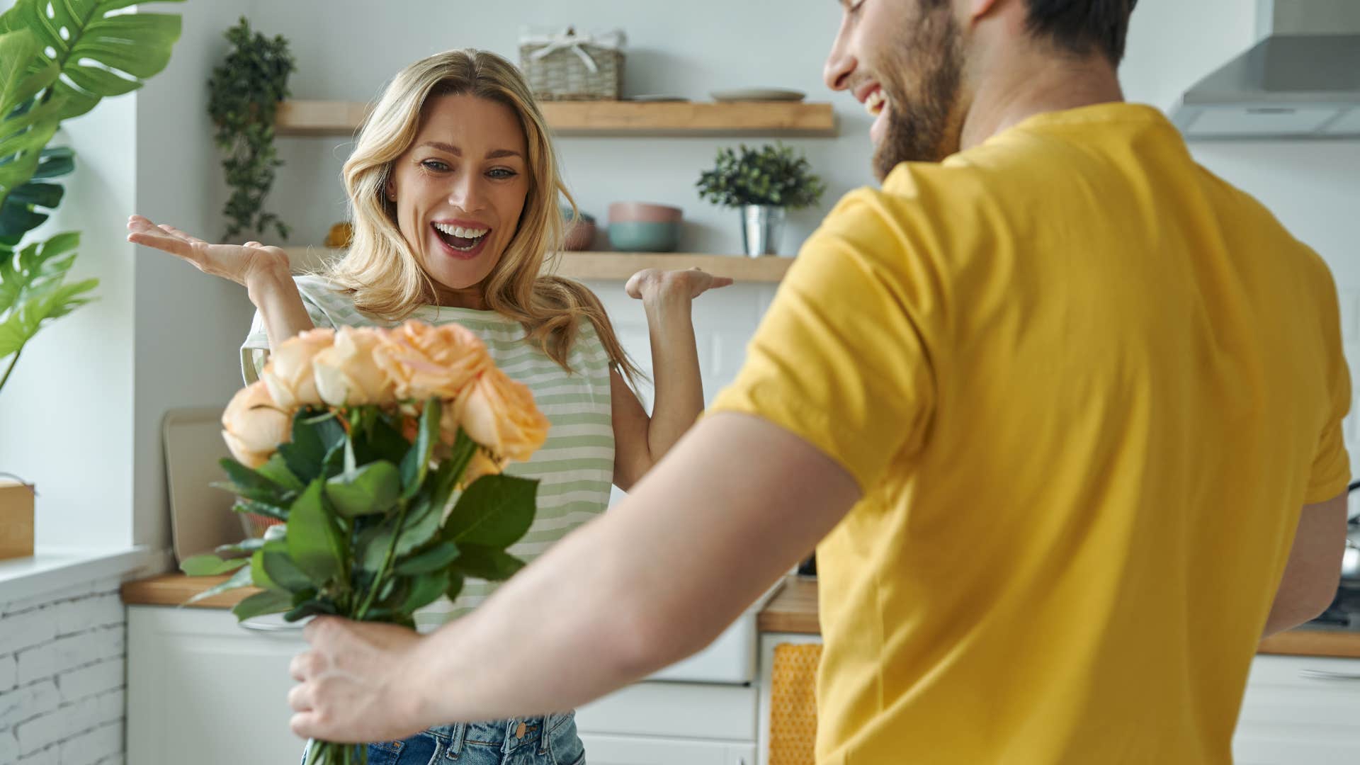 woman looking happy as man promised to keep emotional intimacy alive and got her flowers