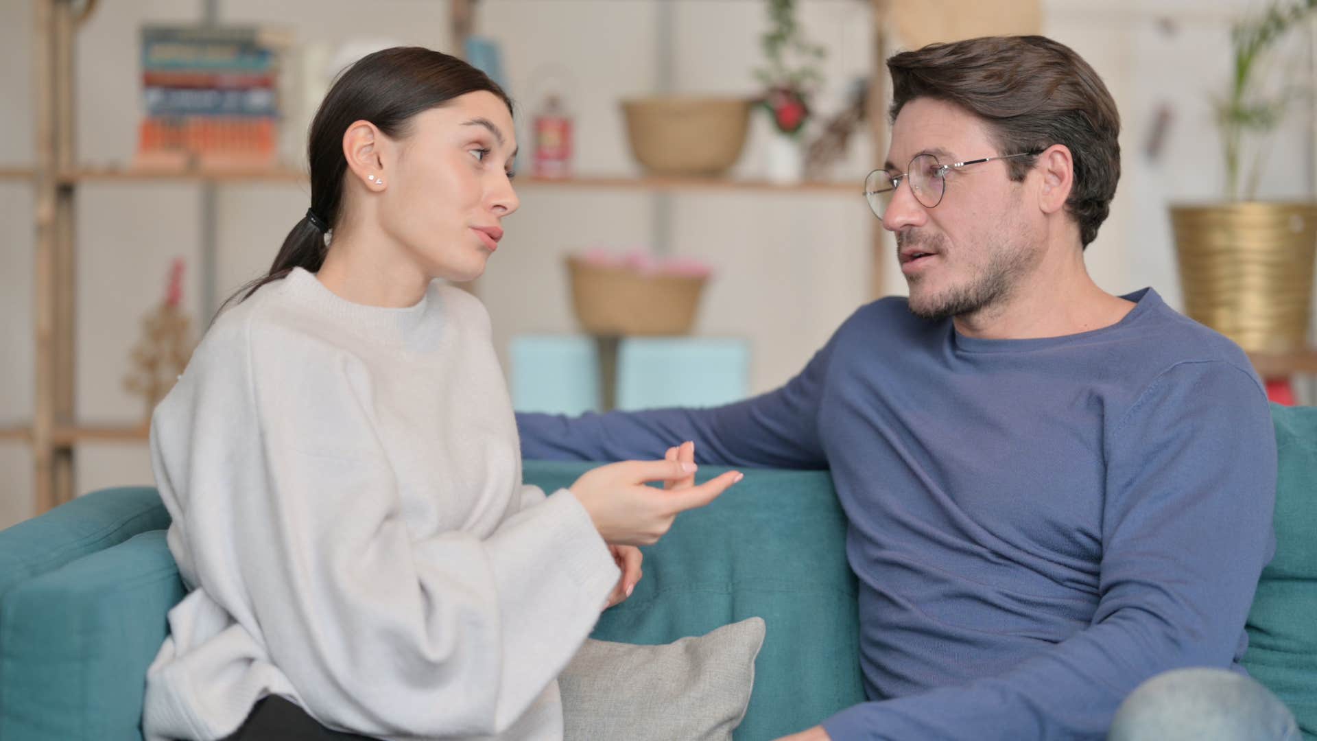 woman in white sweater promises to never go to bed angry as she talks through problems with man