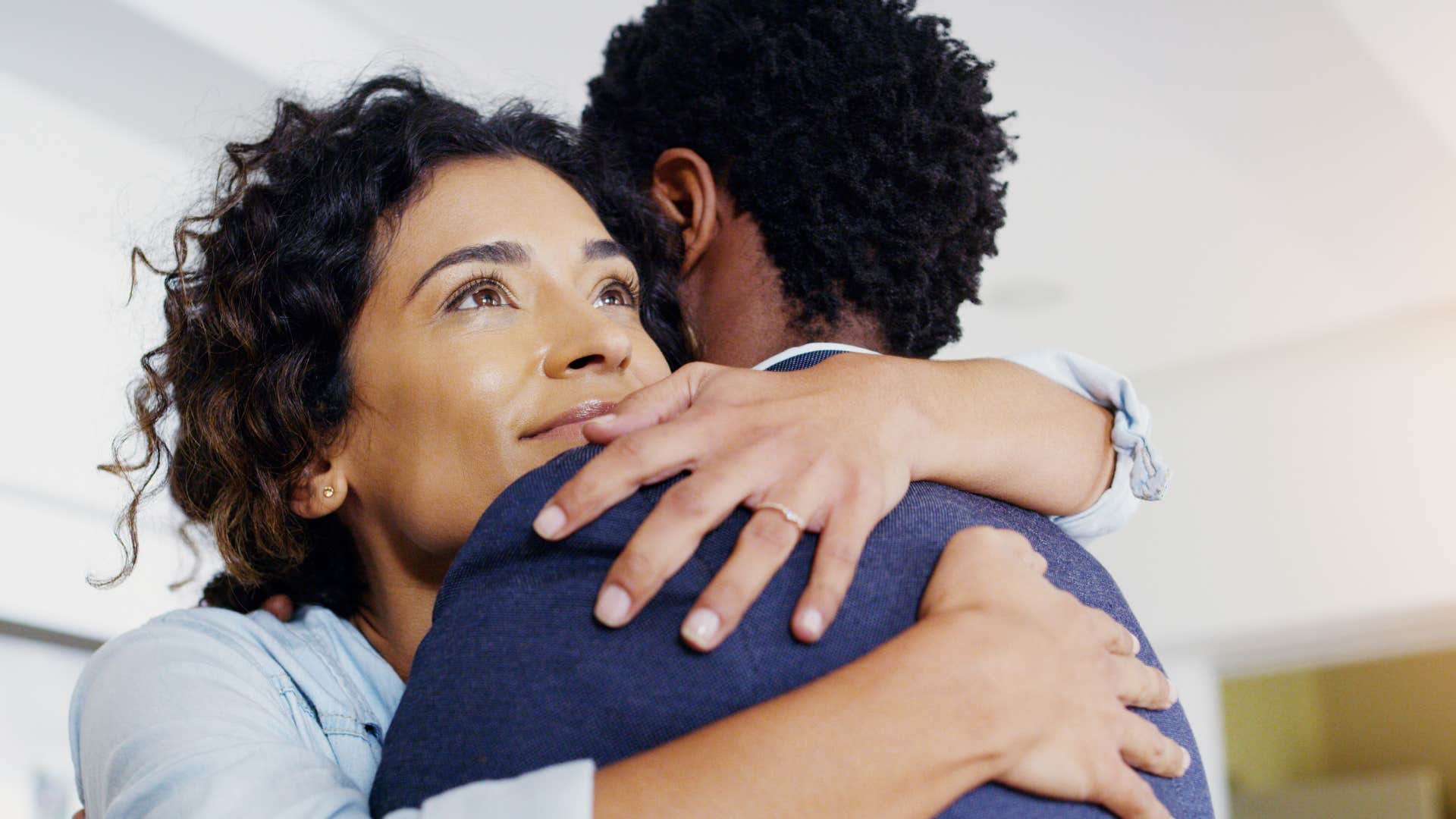 woman in blue hugging man as she promises to stand up for him