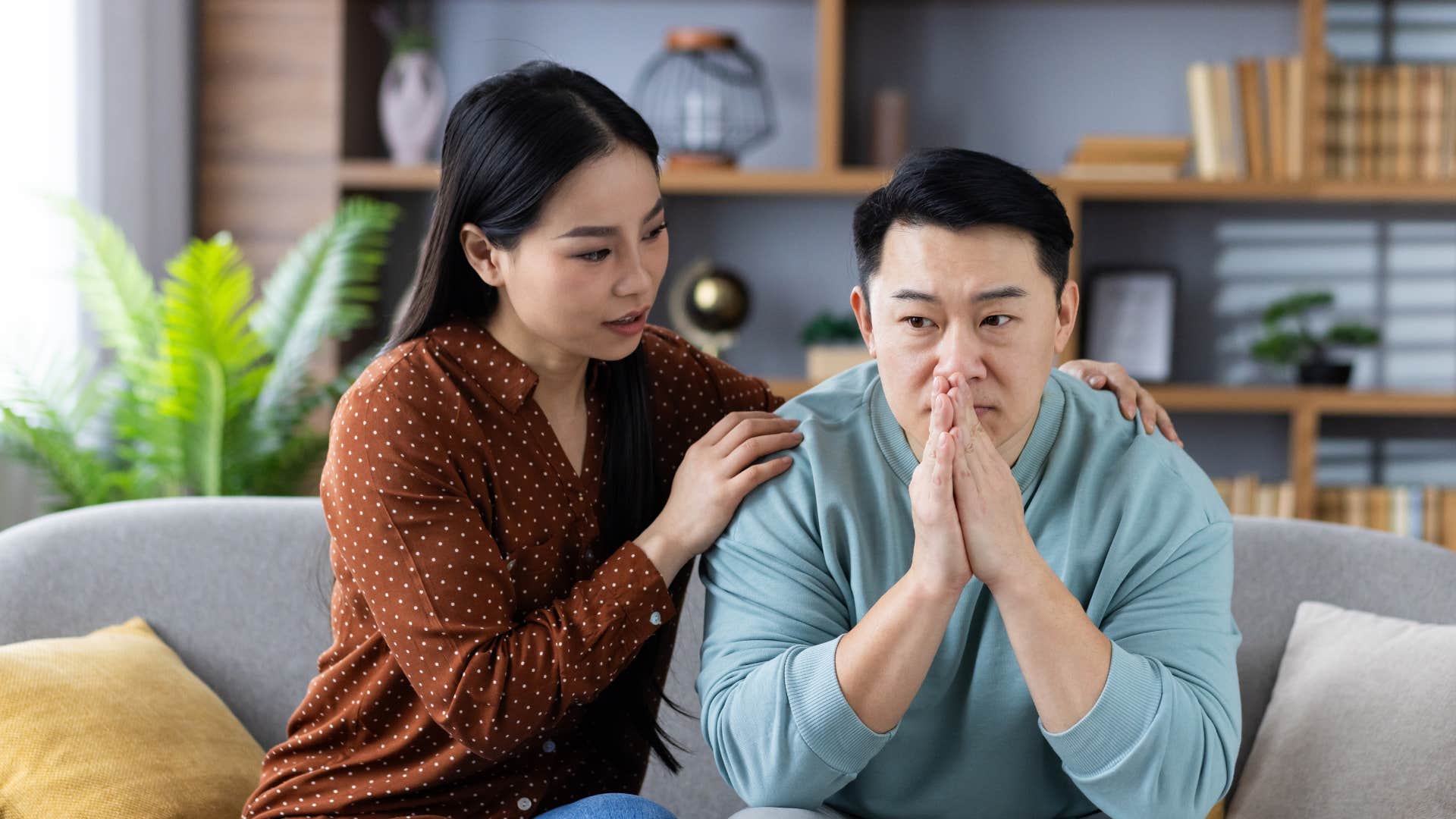 woman in brown shirt promises to support man through the bad times as she comforts him
