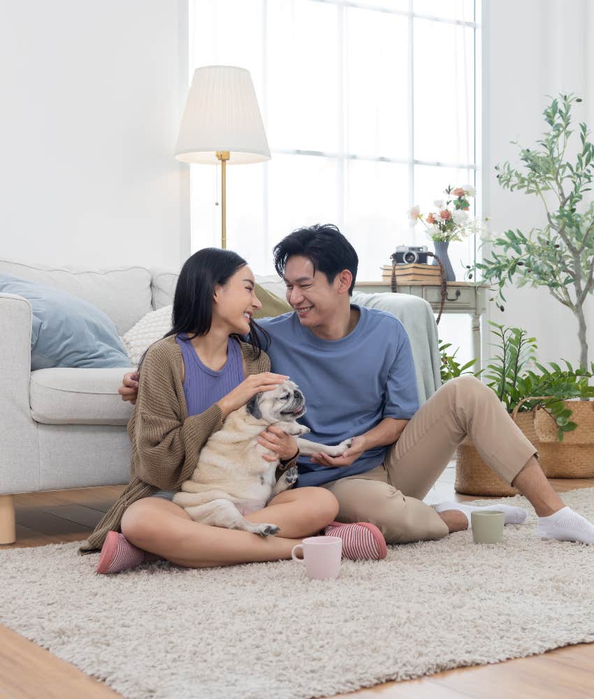 happy couple spending time with pet