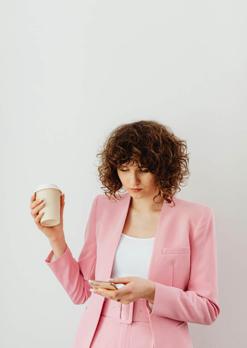 woman on her phone repulsed by social media