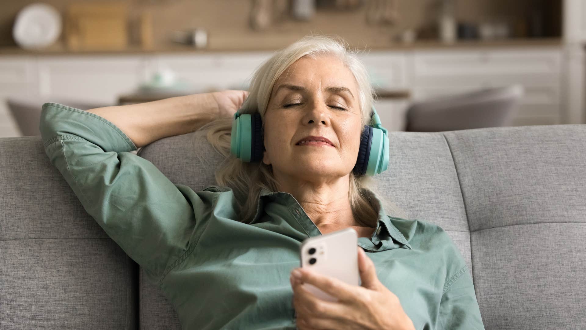 woman relaxing with headphones as she fills the house with noise