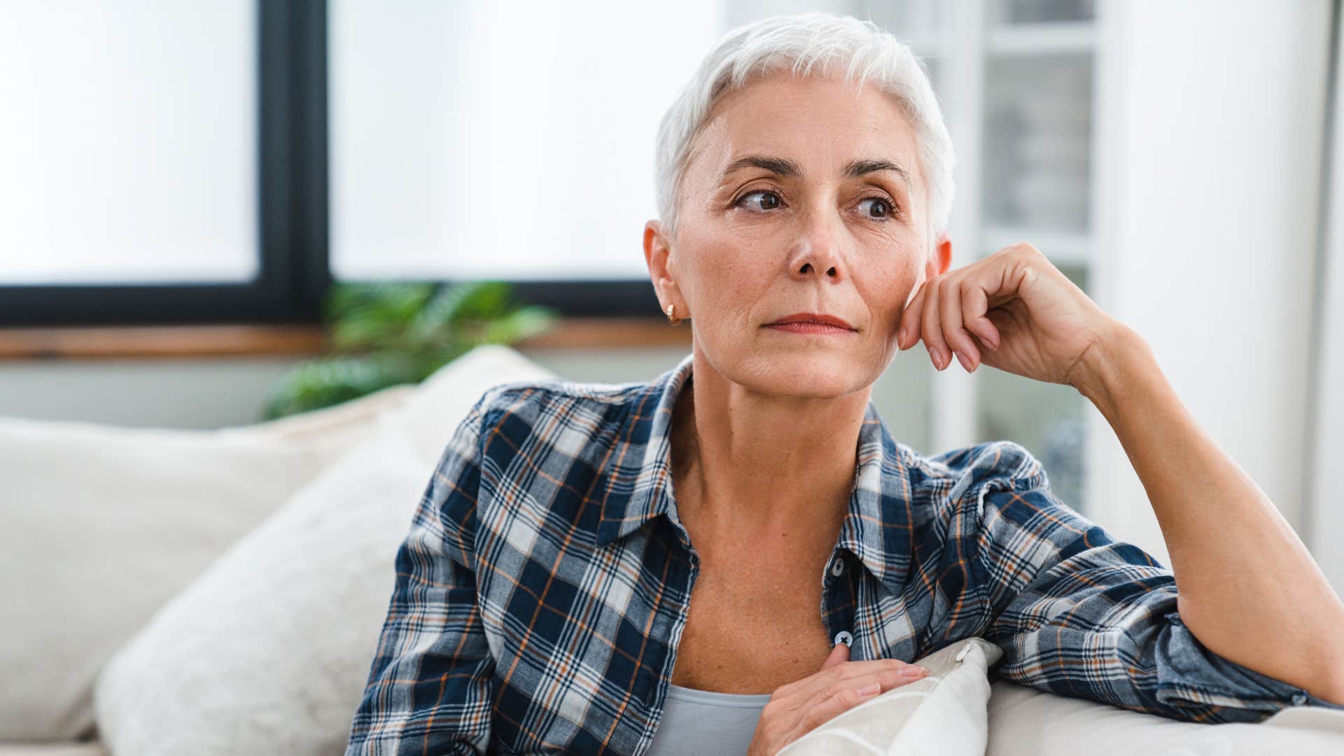 woman in plaid shirt reflecting way too much on the past as she thinks deeply