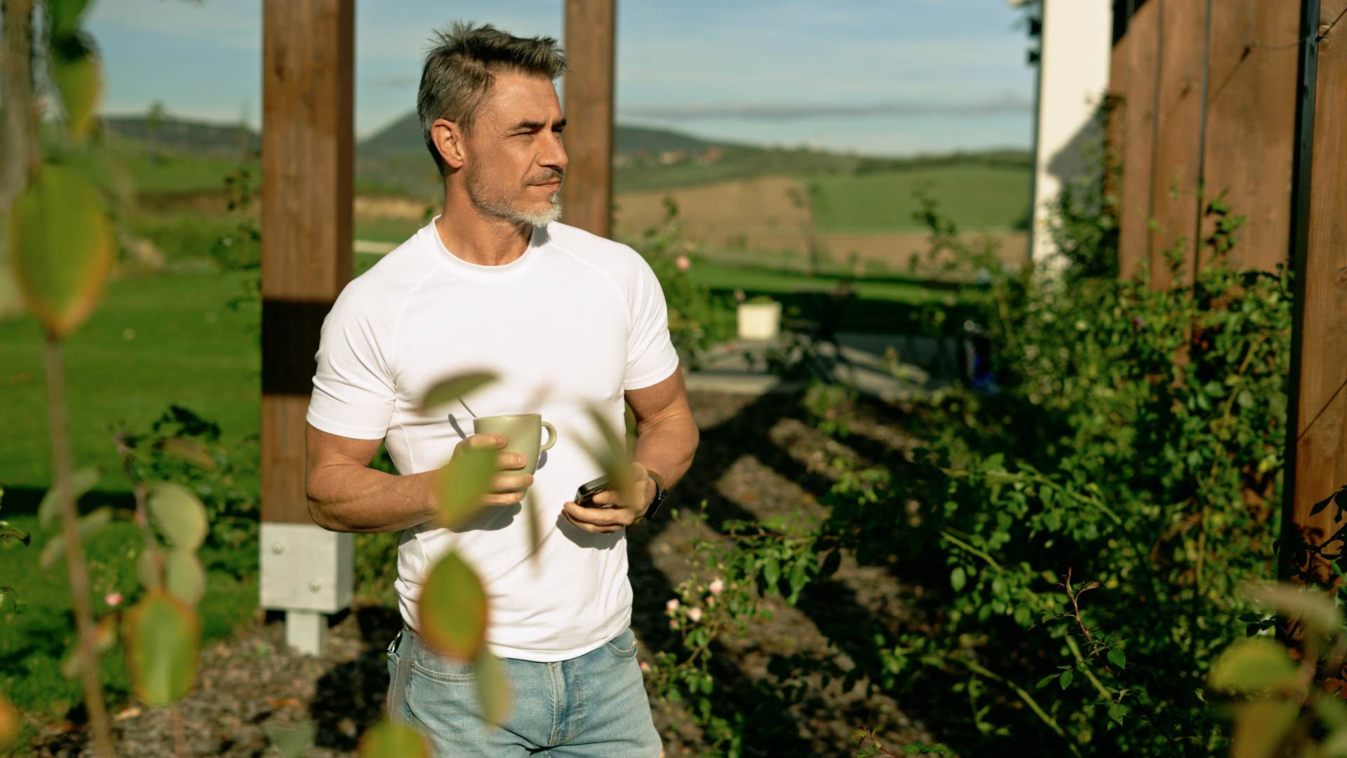 man in white shirt works himself to the point of burnout as he gardens outside