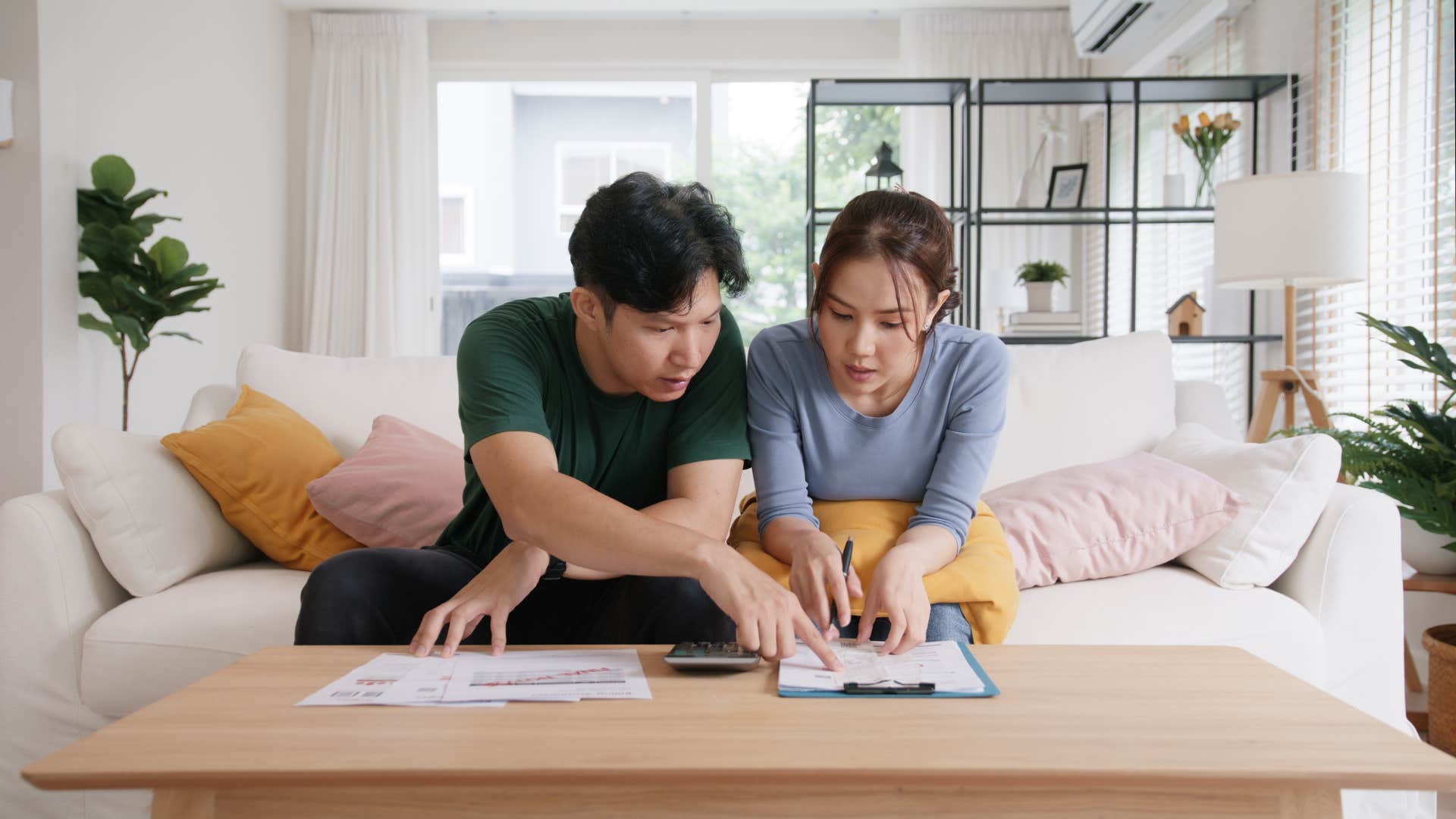 couple struggling financially looking at bills