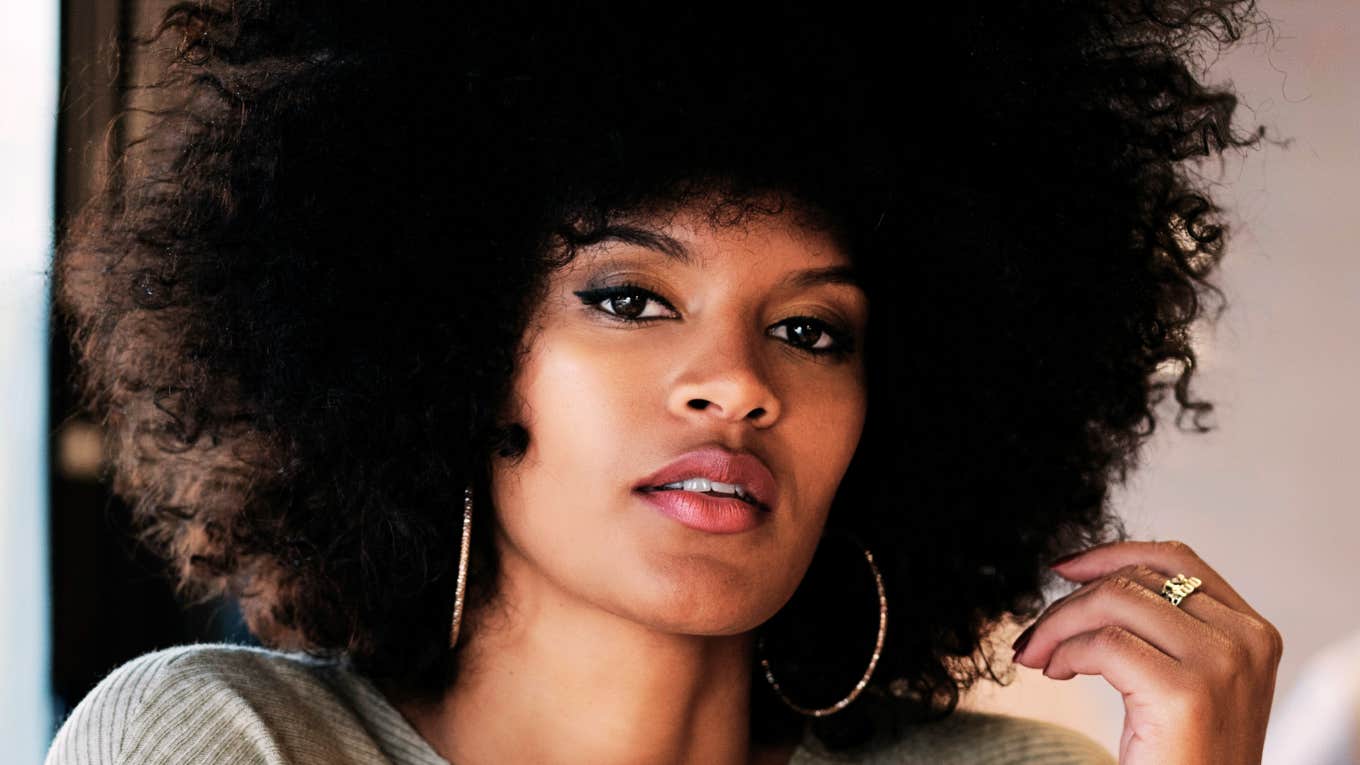 Thoughtful woman with stoic expression, symbolizing reflection on habits and choices that could change her life