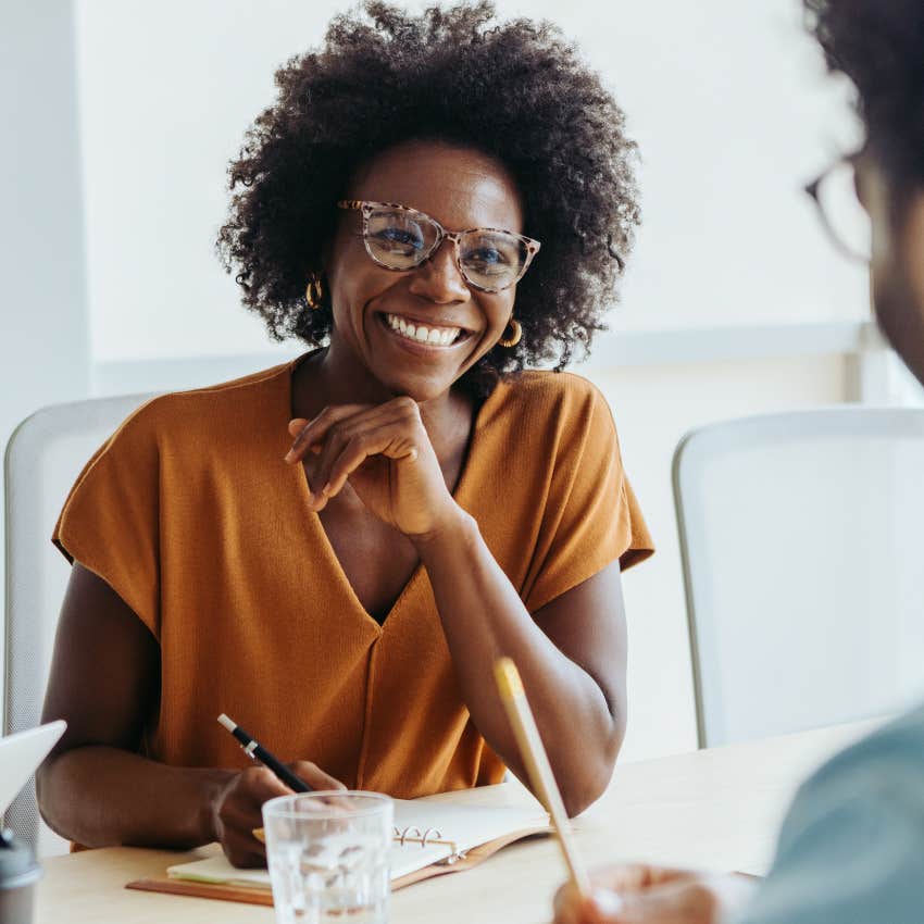 happy smiling woman who knows that putting in effort pays off at work
