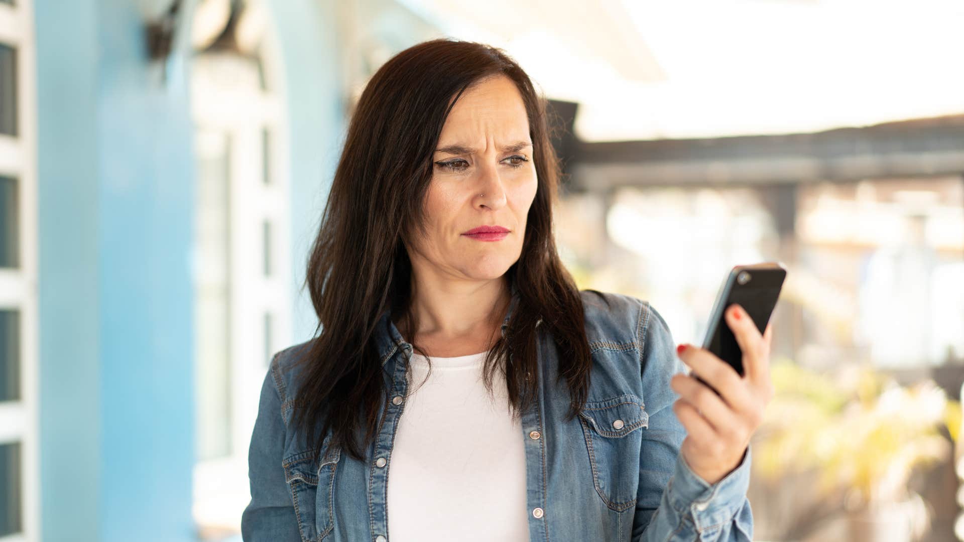 gen x woman annoyed by customer service bots on phone