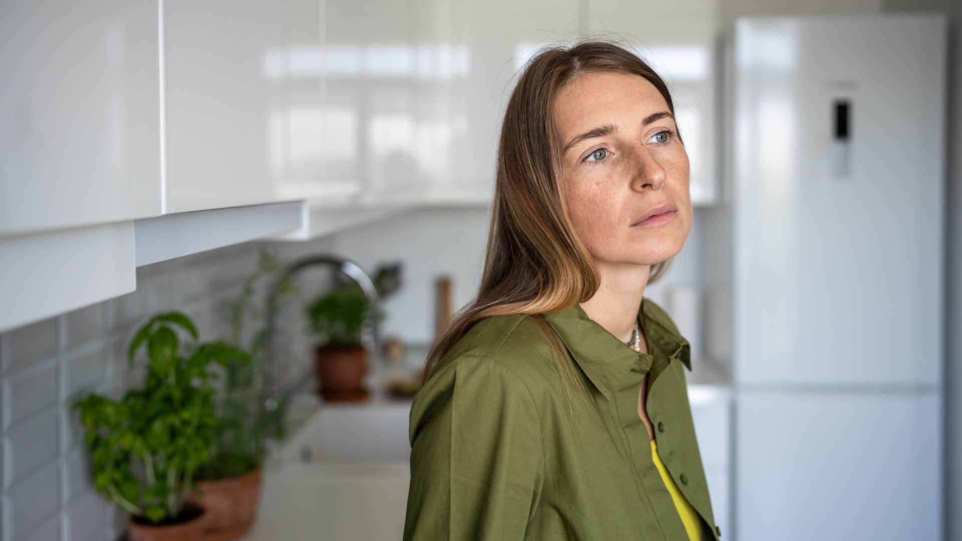 gen x woman stressed by smart appliances in her kitchen