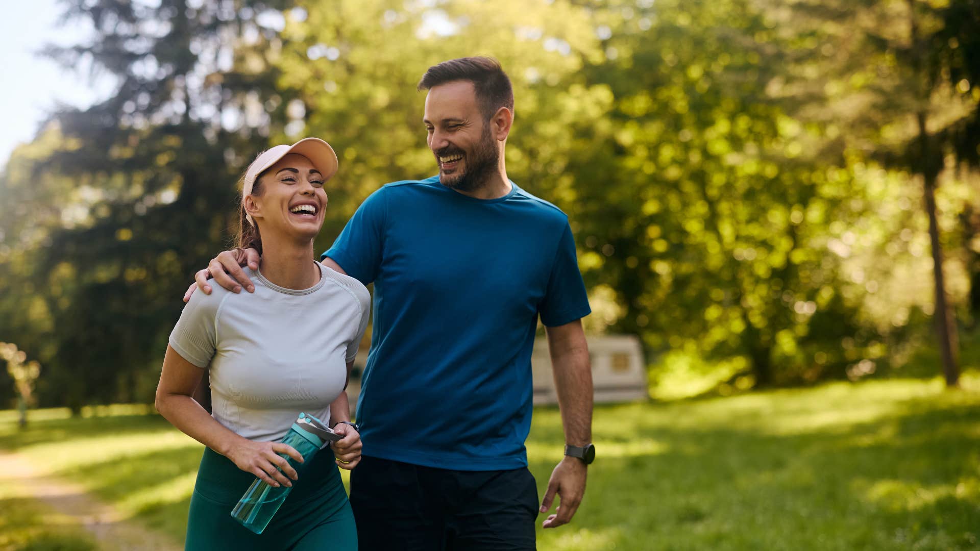 husband and wife walking together in park