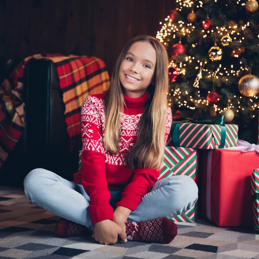 Granddaughter with a bigger pile of gifts than her adopted siblings