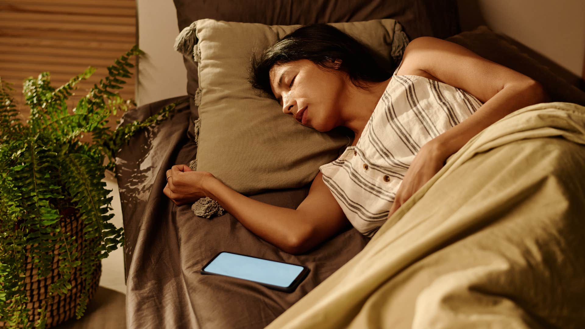 woman filling home with plants as it helps her sleep better