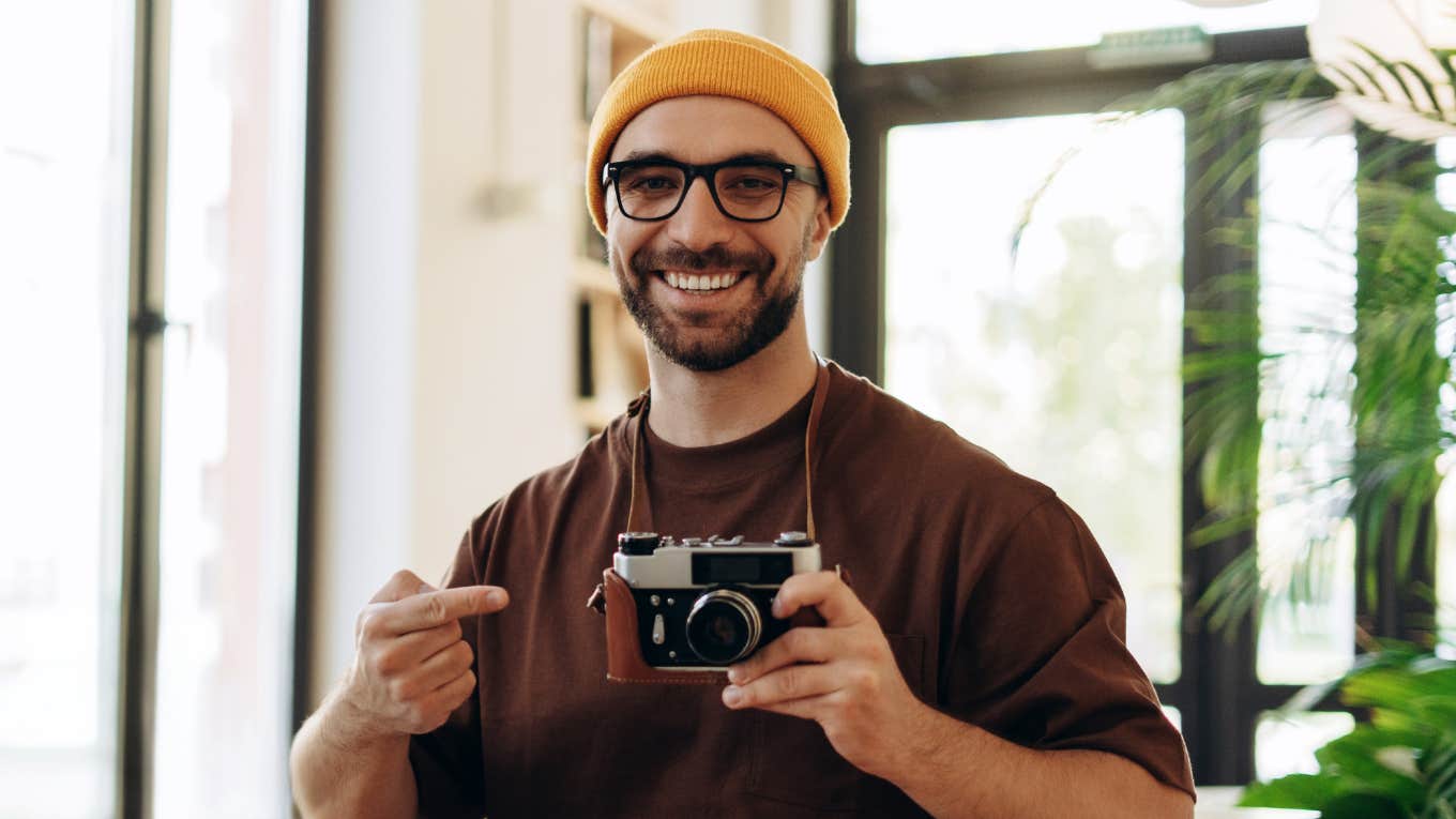 pretentious man showing off photography hobby