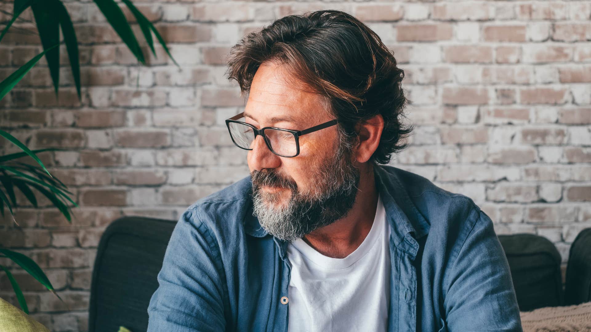 sad man thinking hes fine alone