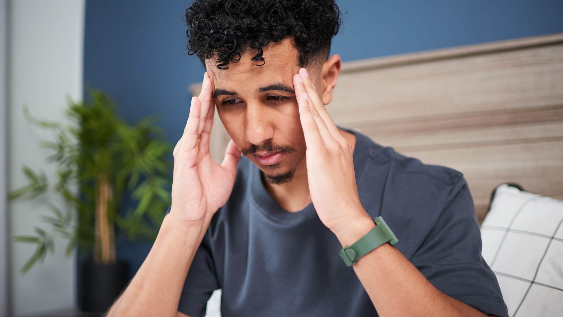 stressed man sitting in bed worried about next day