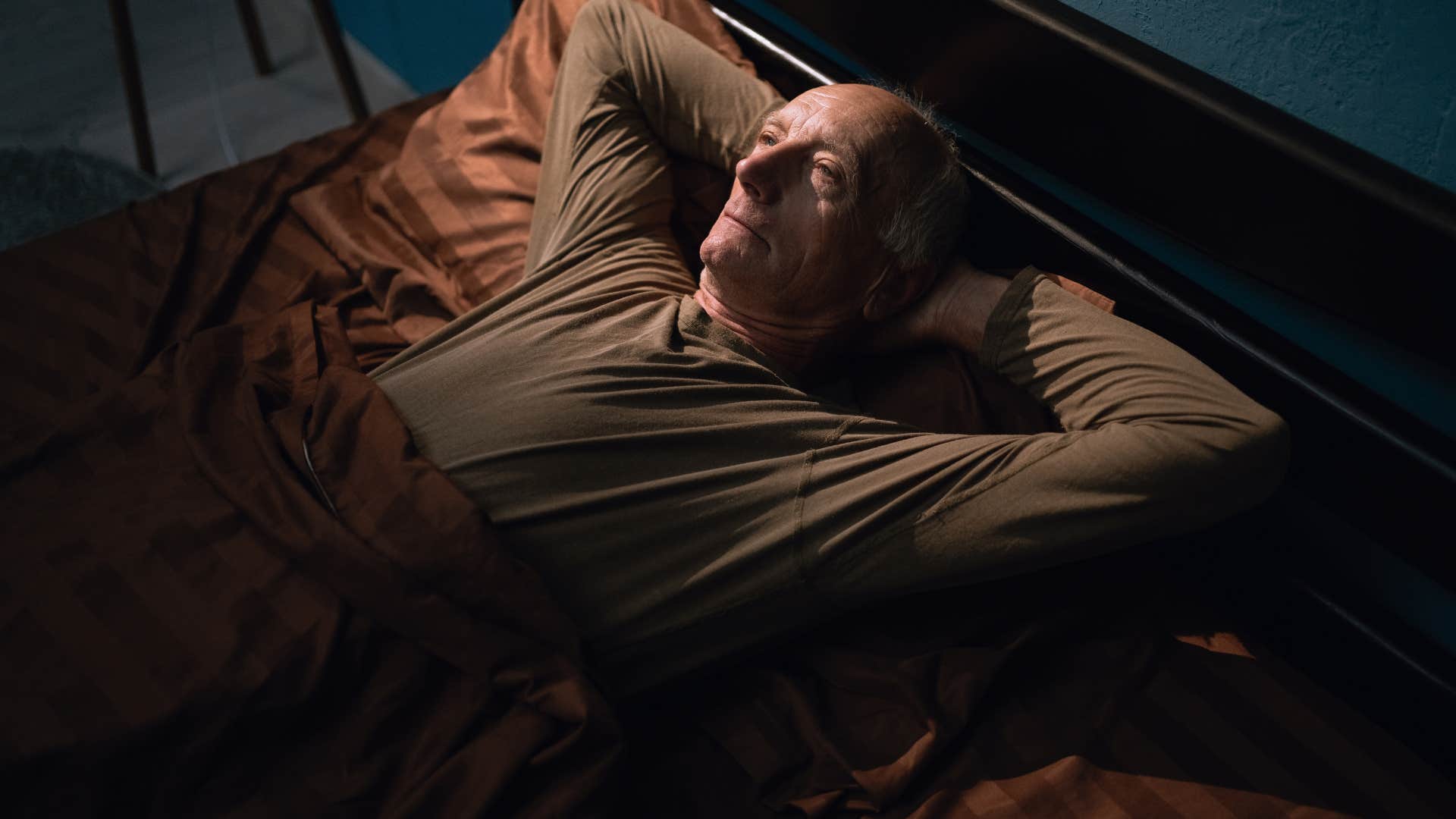 lonely man in bed longing for conversation with wife