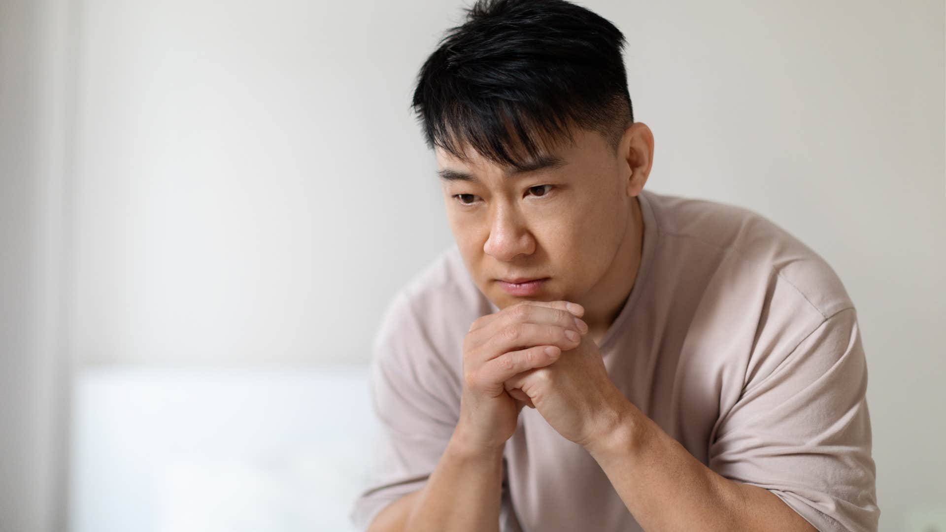 man in deep thought feeling a bit jealous of wife