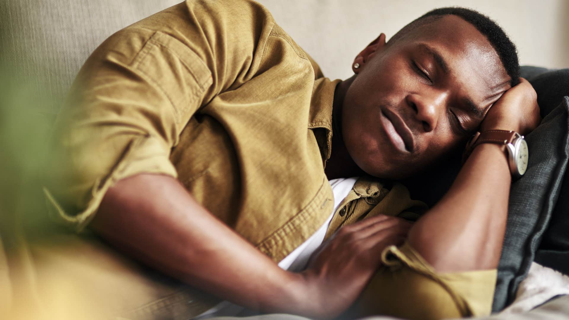 man avoiding intimacy sleeping on the couch