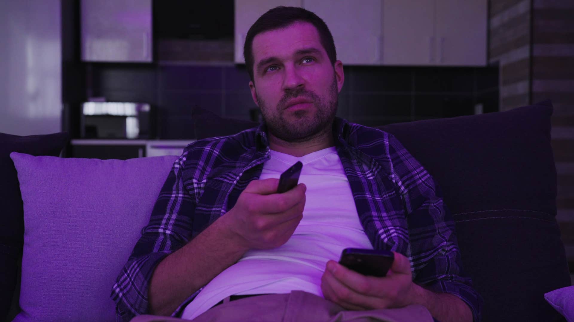 man on his own schedule watching tv late at night