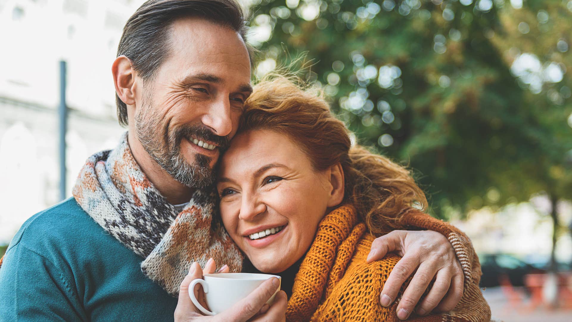 consistent man smiling and hugging his partner