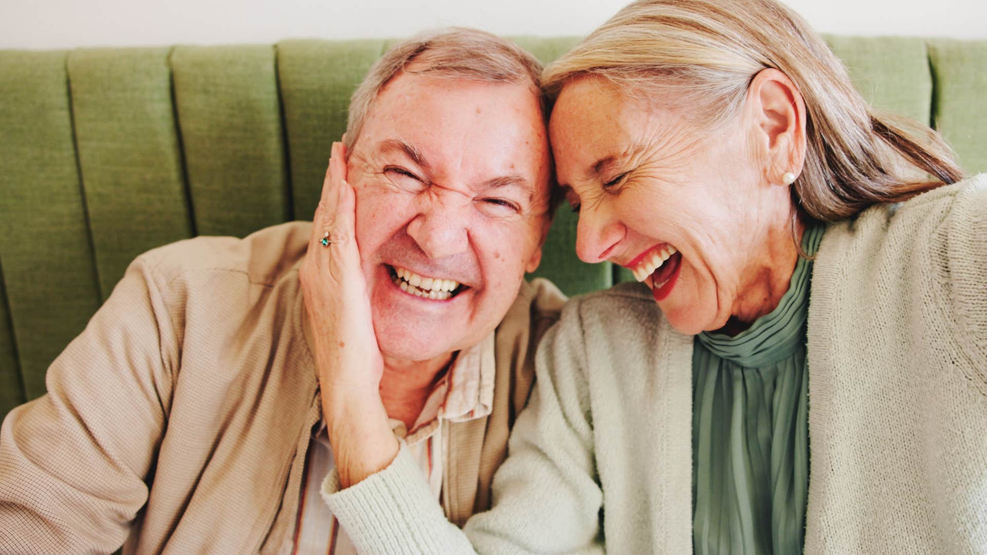 man who's not afraid of his partners emotions laughing with her